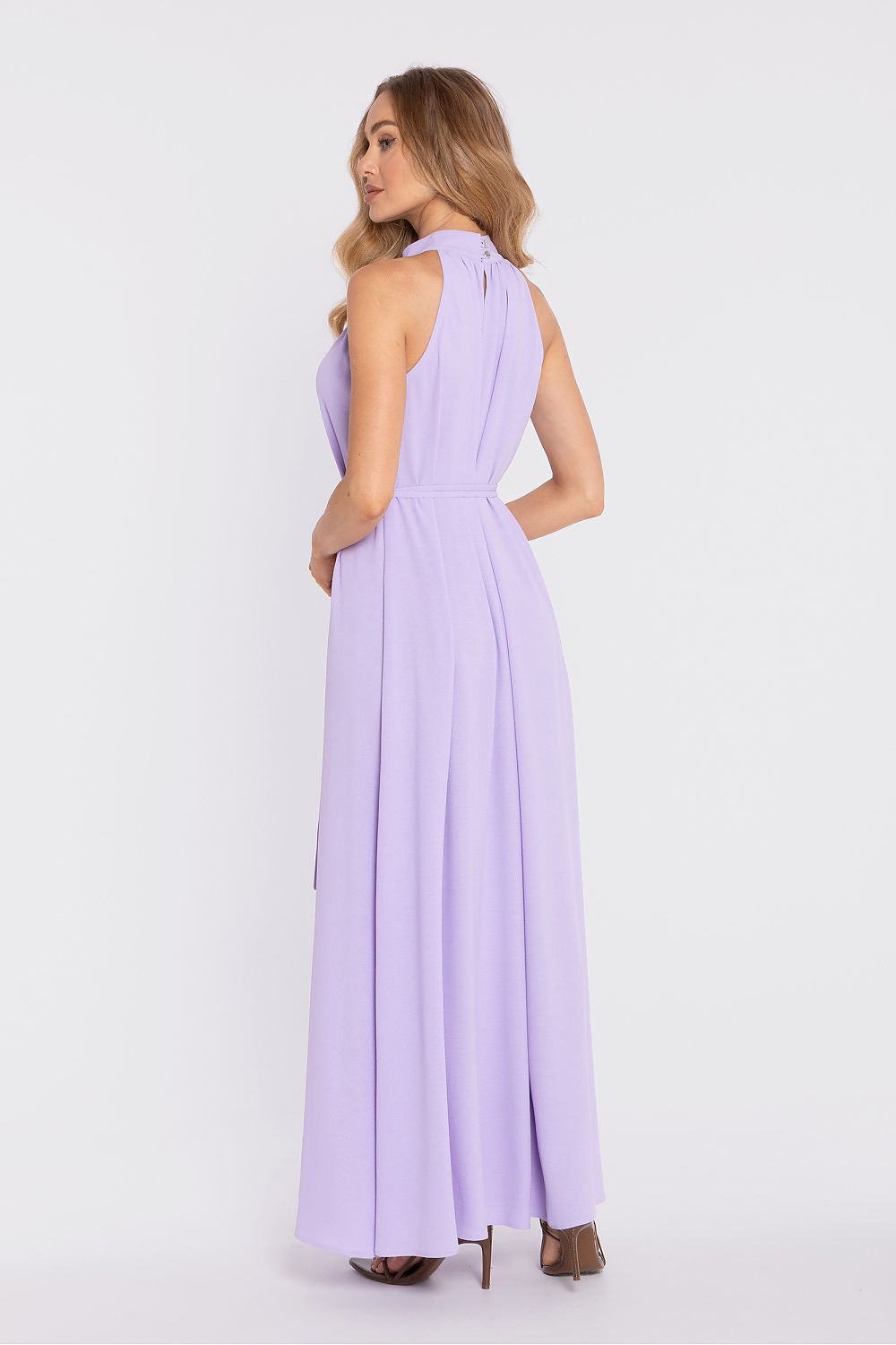 Woman wearing a lavender halter neck jumpsuit on a white background