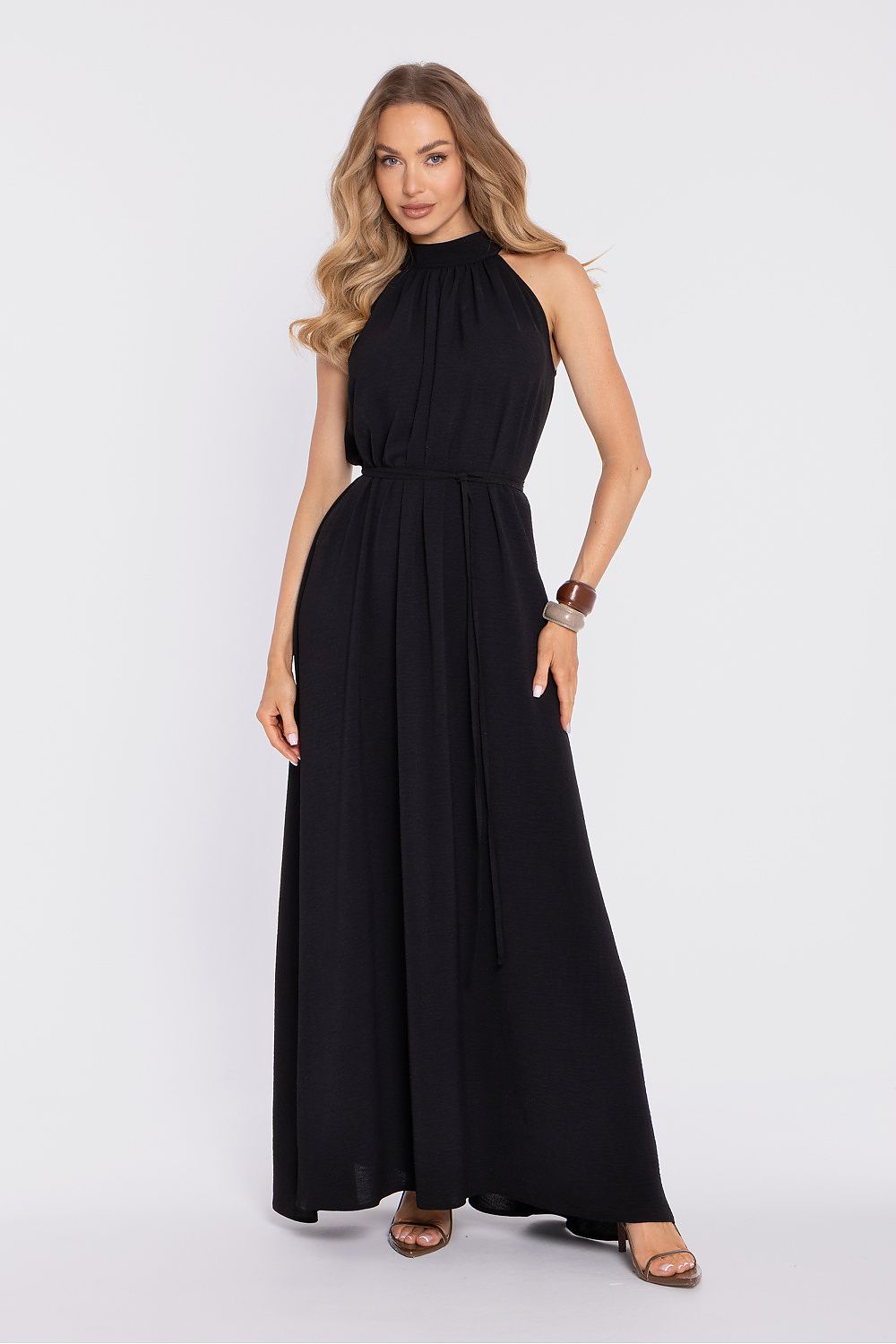 Woman wearing a black sleeveless dress on a white background