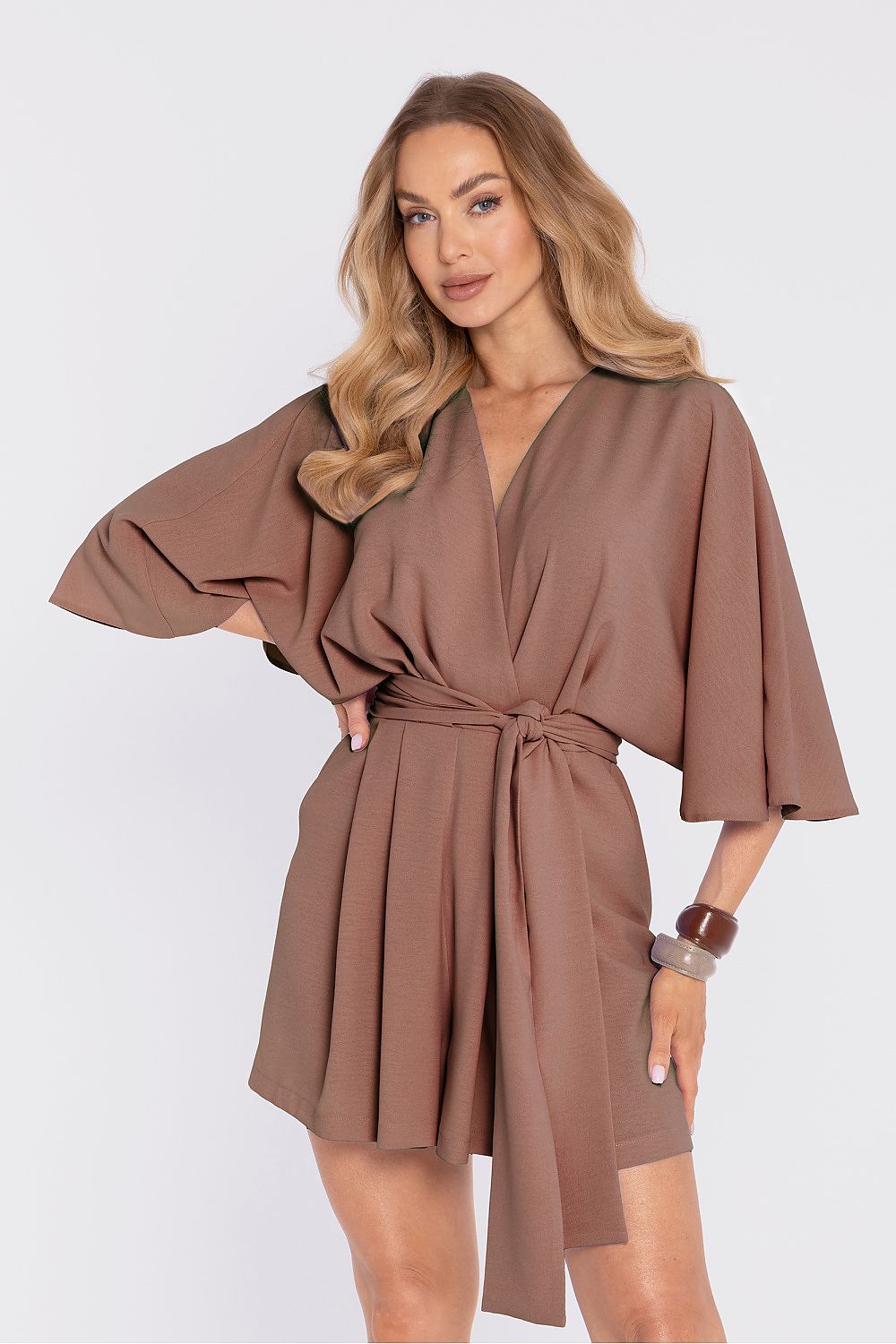 Woman wearing a brown dress with a white background