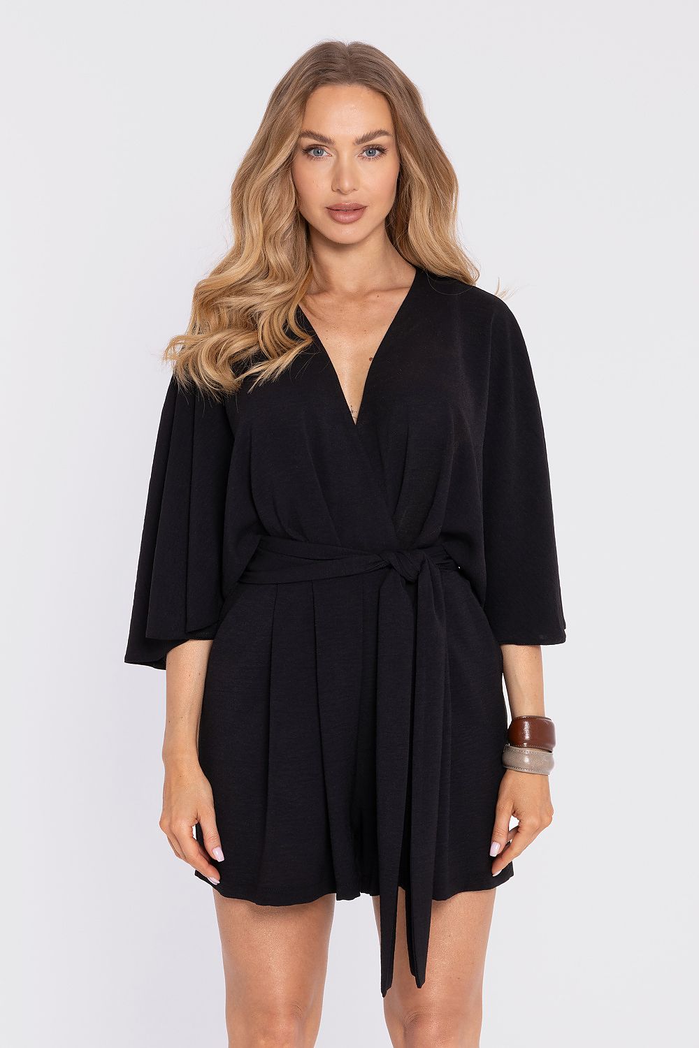 Woman wearing a black dress with a plain background