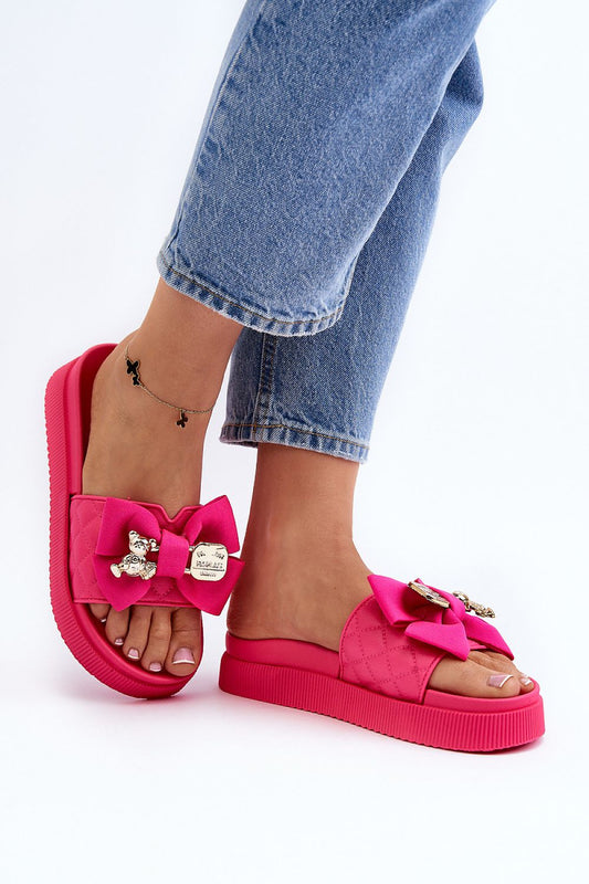 Pink platform sandals with oversized fabric bow and decorative bear buckle detail