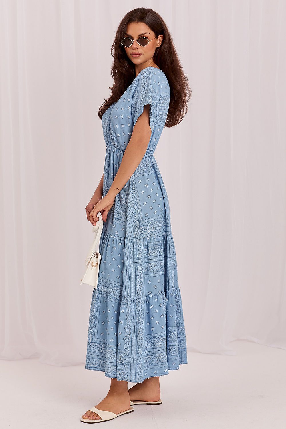The Sienna Breeze Maxi Dress in blue featuring a flattering wrap neckline and flowing printed maxi skirt