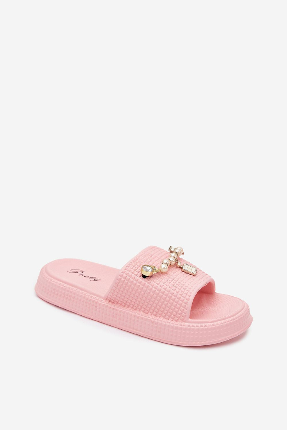 A single pink slide sandal with a textured strap and a decorative bow embellished with small pearls and gold-toned beads, shown on a light gray background.