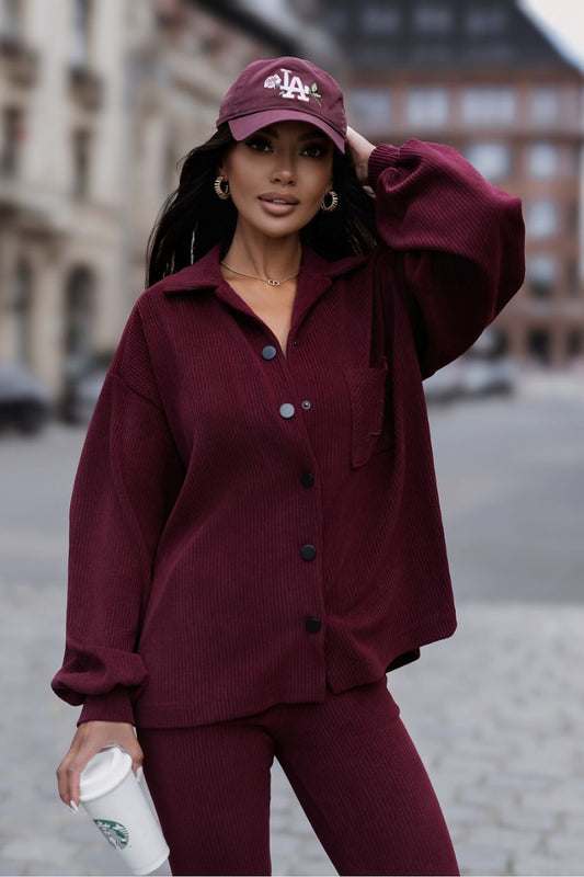  Women's red corduroy two-piece set with relaxed shirt and matching trousers.