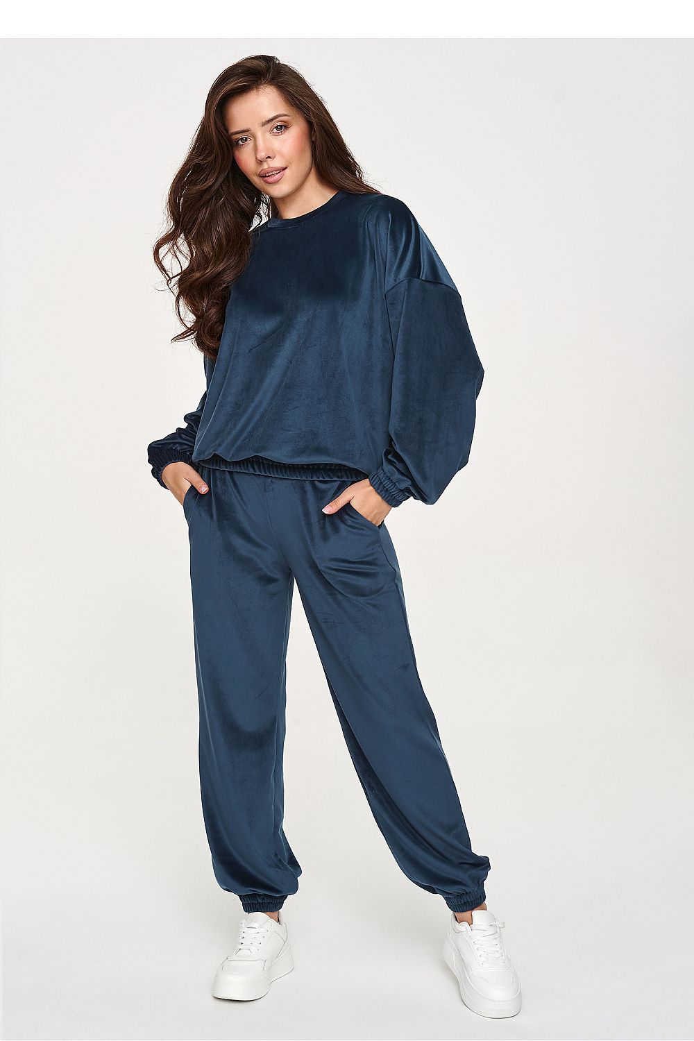 Women's blue velour two-piece set with relaxed sweatshirt and jogger trousers.