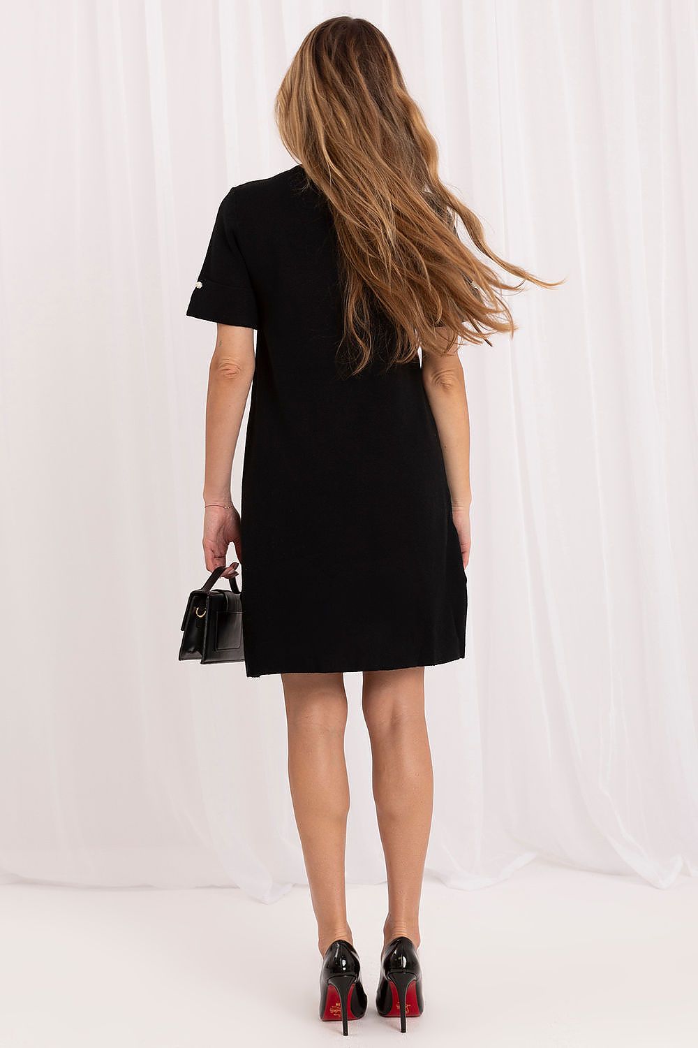 Women's black knee-length dress with jet embellishments across the front