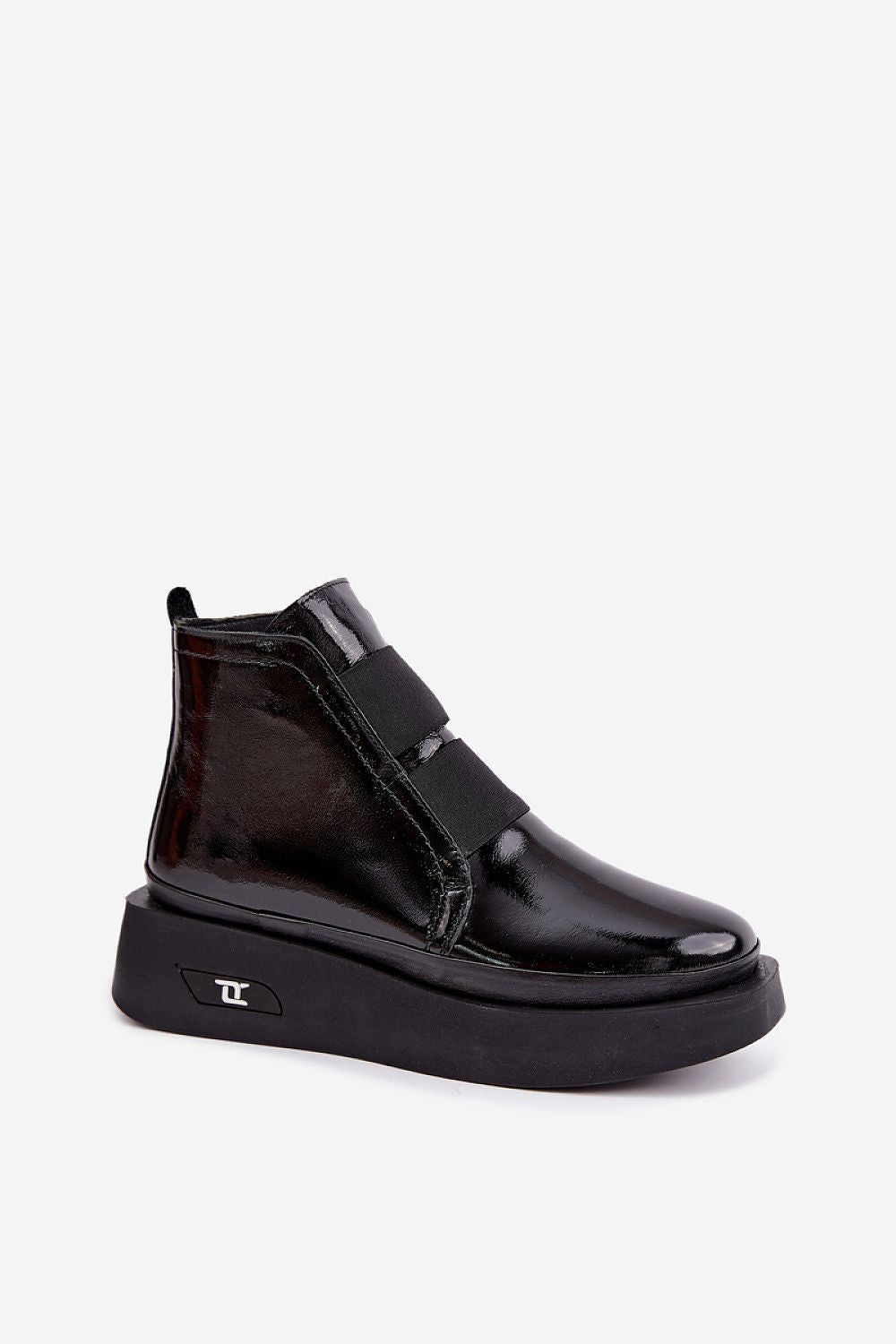 A black patent leather ankle boot with a platform sole and a wide hook-and-loop strap across the upper, shown from a three-quarters angle on a light gray background.