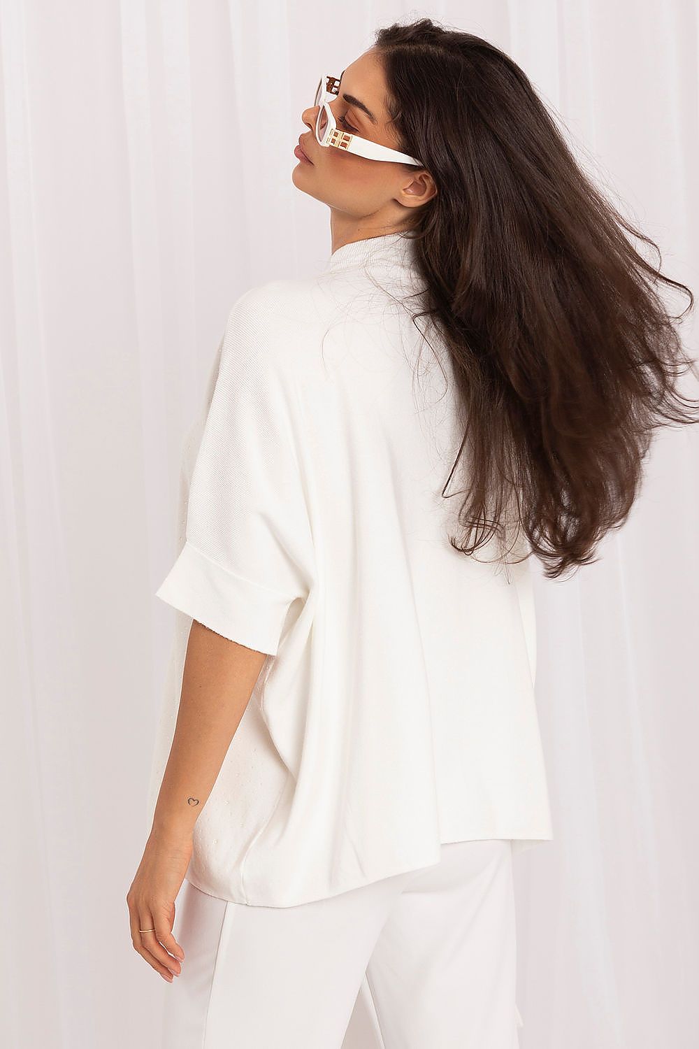 Women's white studded turtleneck sweater styled for elegant everyday and occasion wear