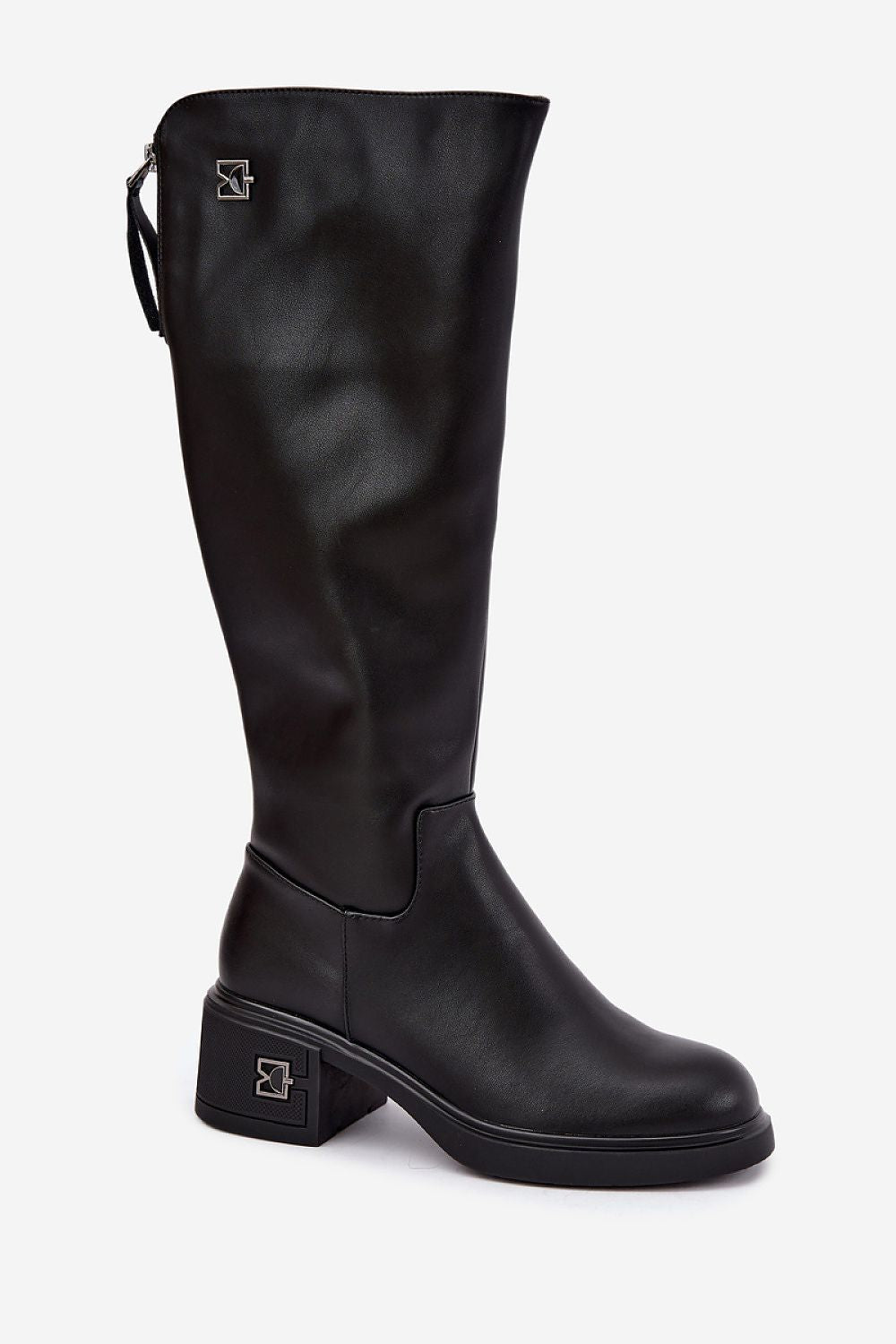 A black leather knee-high boot with a low block heel and a small silver geometric logo on the heel and upper shaft, shown against a plain light gray background.