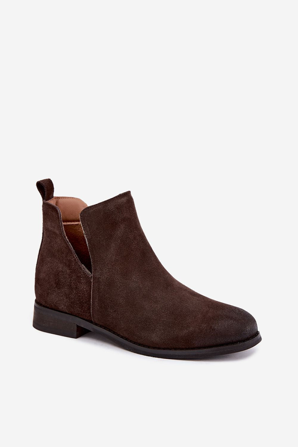 A dark brown suede Chelsea boot with a low block heel and pull tab, shown from a side profile on a light gray background.