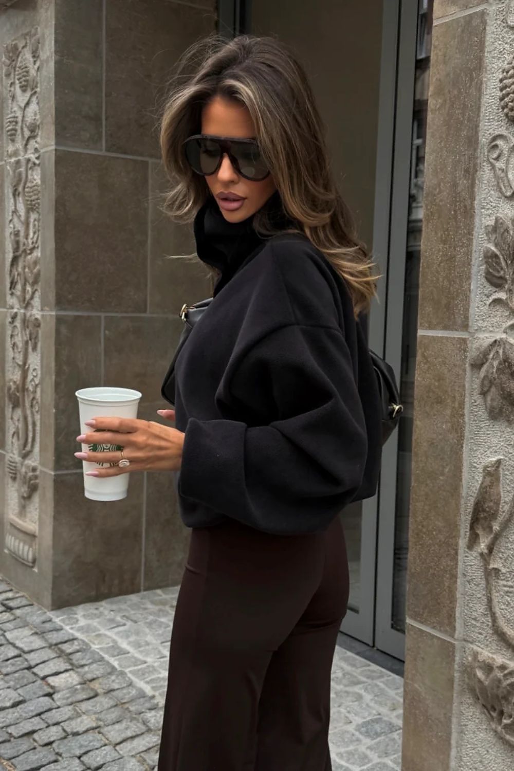Black relaxed fit women's sweatshirt styled with jeans-side-view