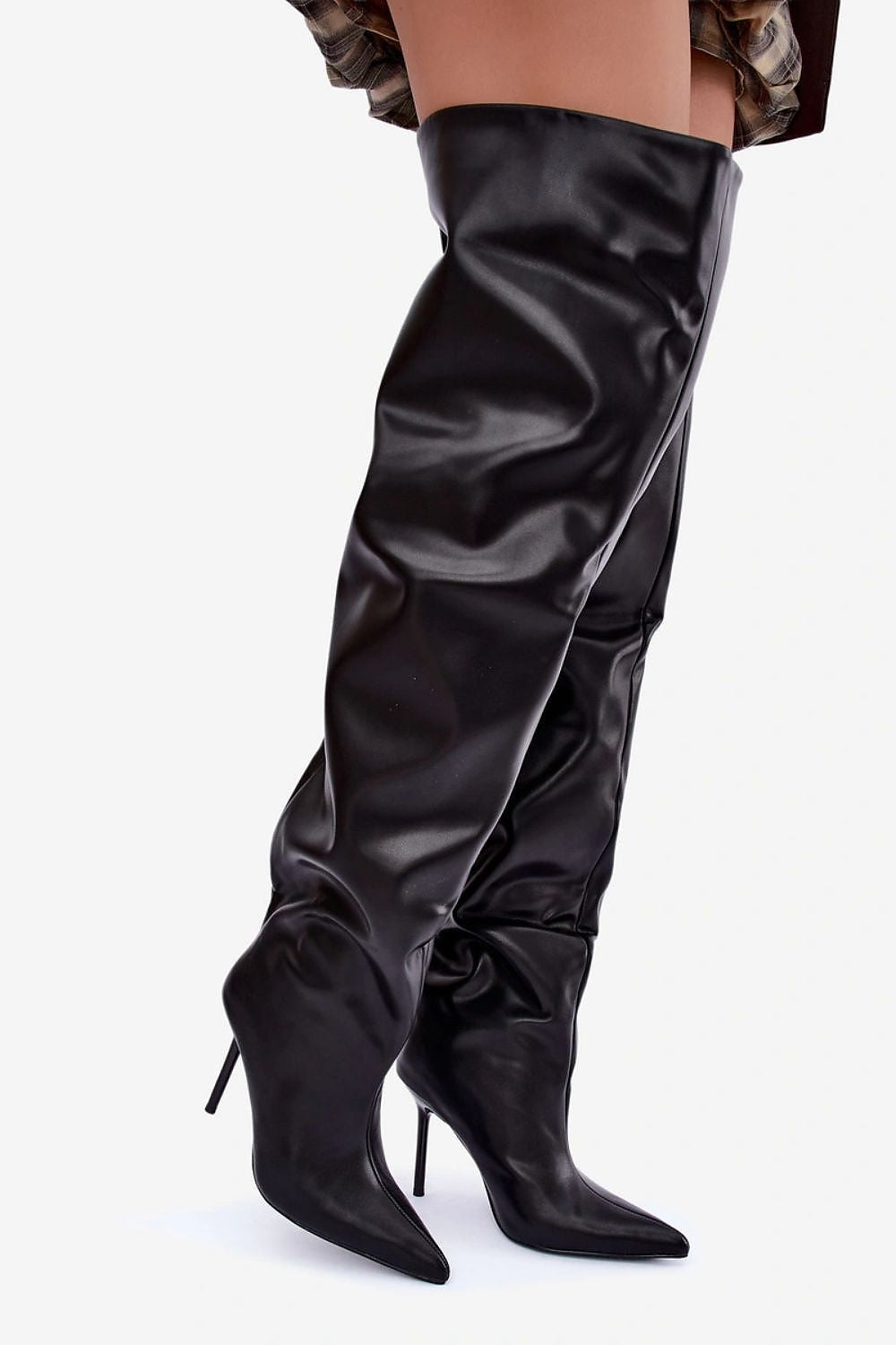 A pair of black faux-leather over-the-knee boots with pointed toes and slim high heels, shown on a model's legs against a light gray background.