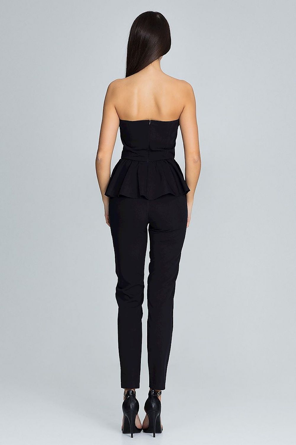 Black strapless top and pants worn by a model on a gray background