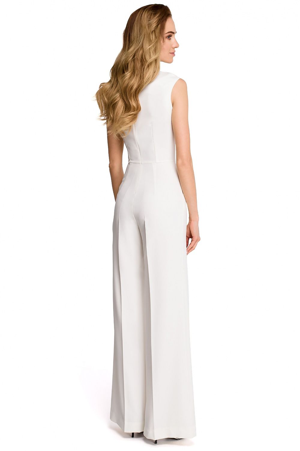 Woman wearing a white sleeveless jumpsuit on a white background