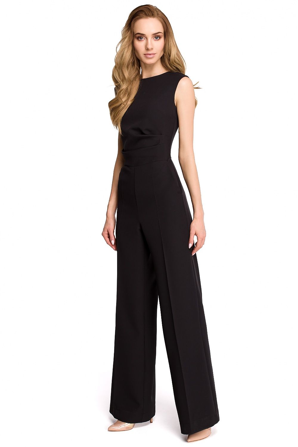 Woman wearing a black jumpsuit on a white background
