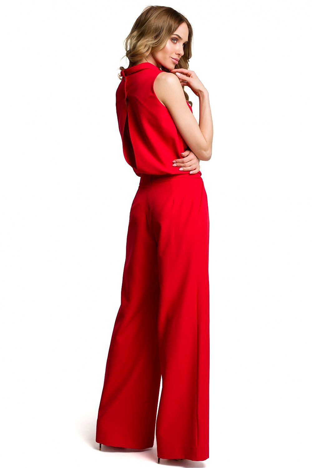 Woman wearing a red jumpsuit on a white background