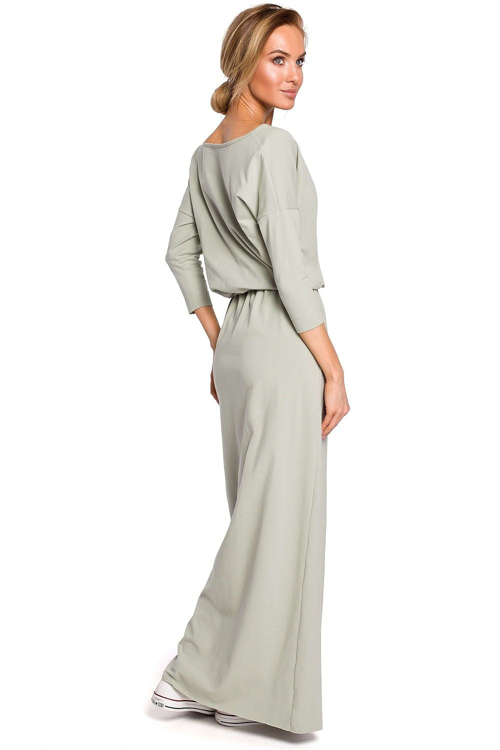 Woman wearing a light green dress on a white background