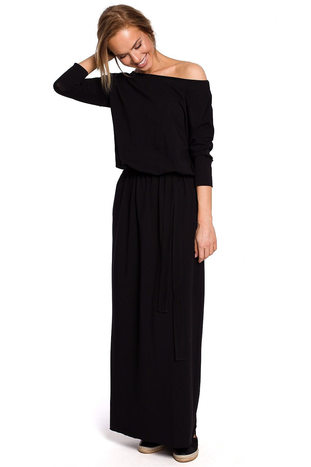 Woman wearing a black off-shoulder dress on a white background