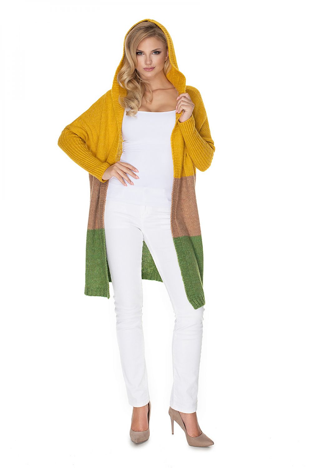 Woman wearing a mustard yellow and green cardigan over a white outfit on a white background
