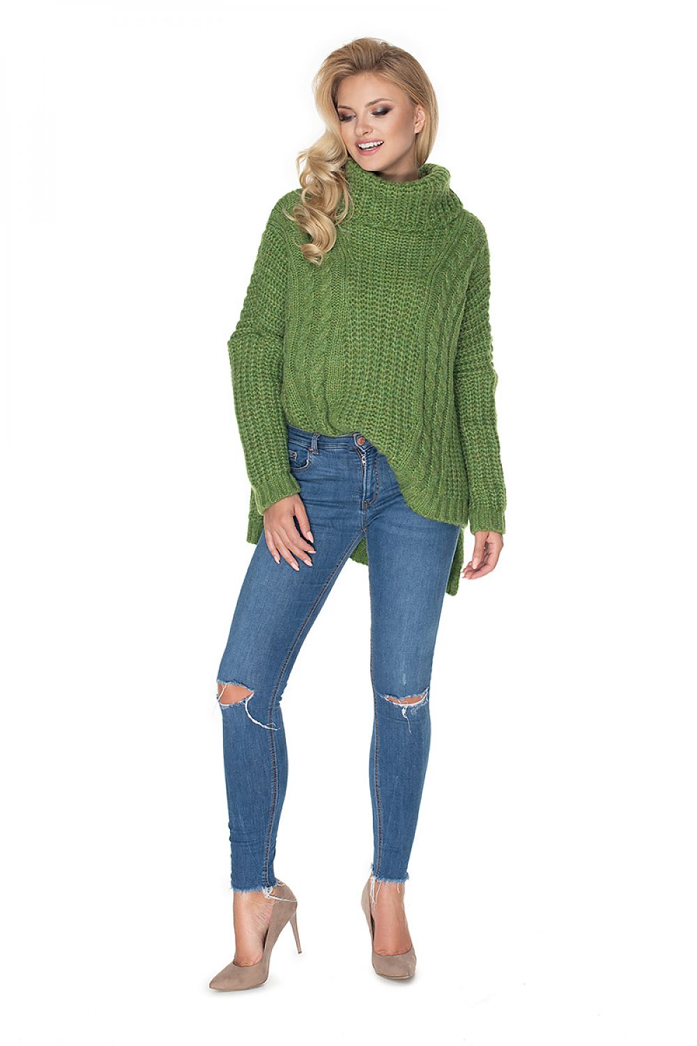 Woman wearing a green knitted sweater and blue jeans on a white background