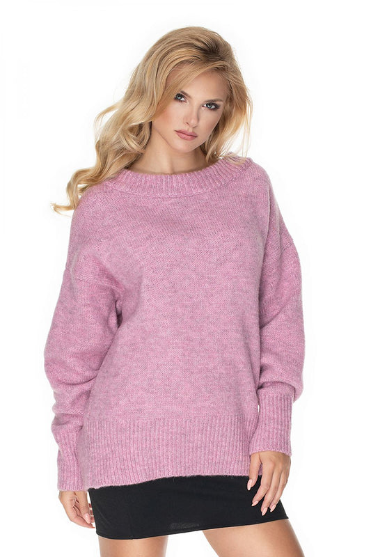 Woman wearing a pink sweater on a white background