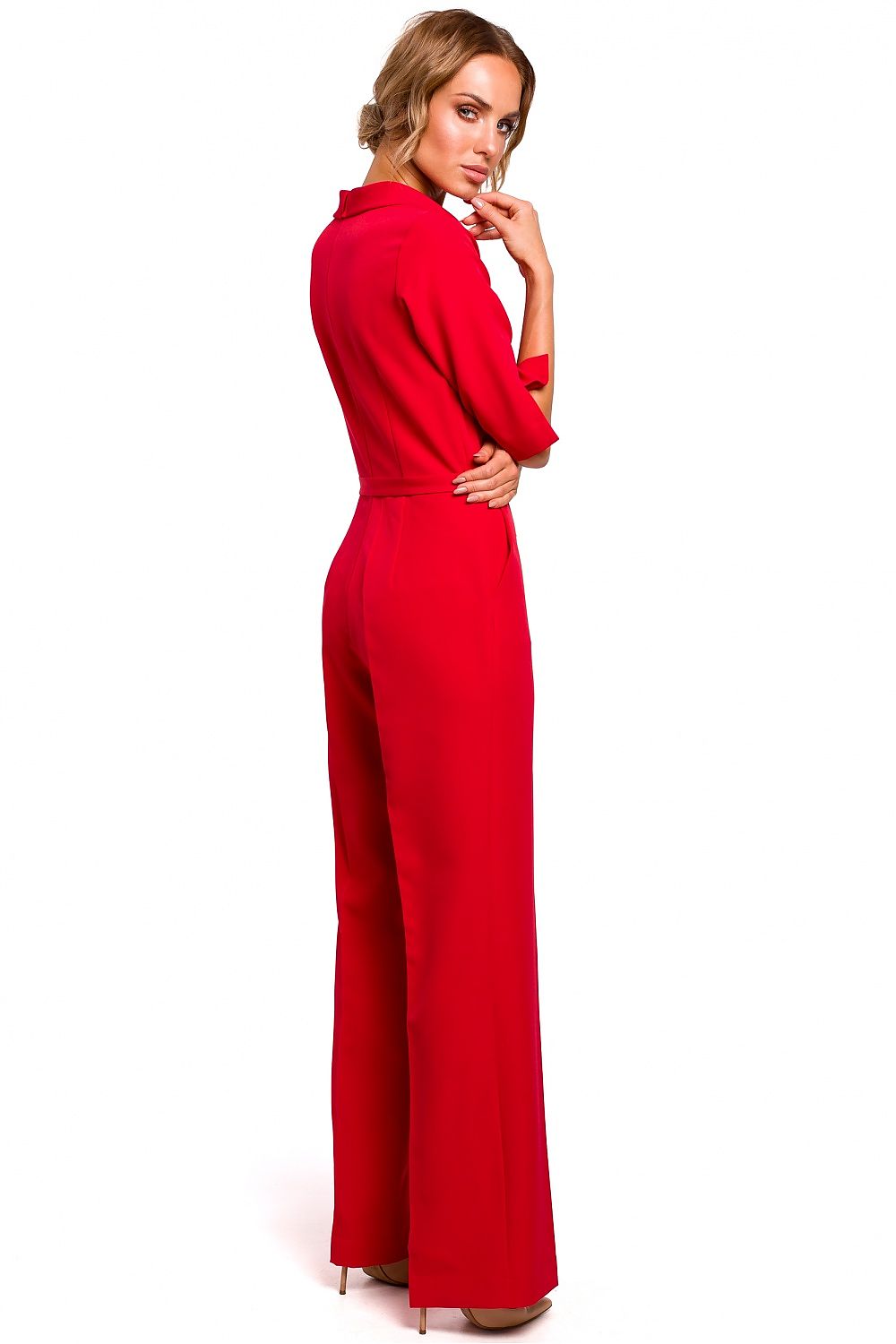 Woman wearing a red jumpsuit on a white background
