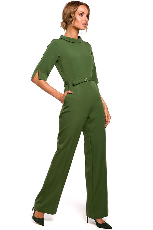 Woman wearing a green jumpsuit on a white background