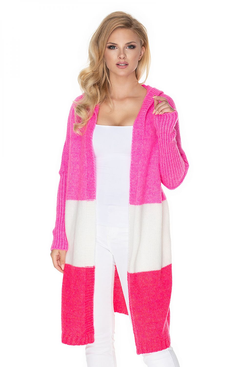 Woman wearing a long pink and white cardigan on a white background