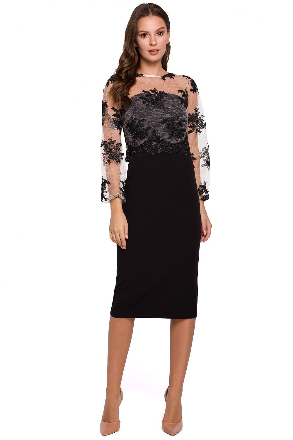 Woman wearing a black dress with floral lace sleeves on a white background