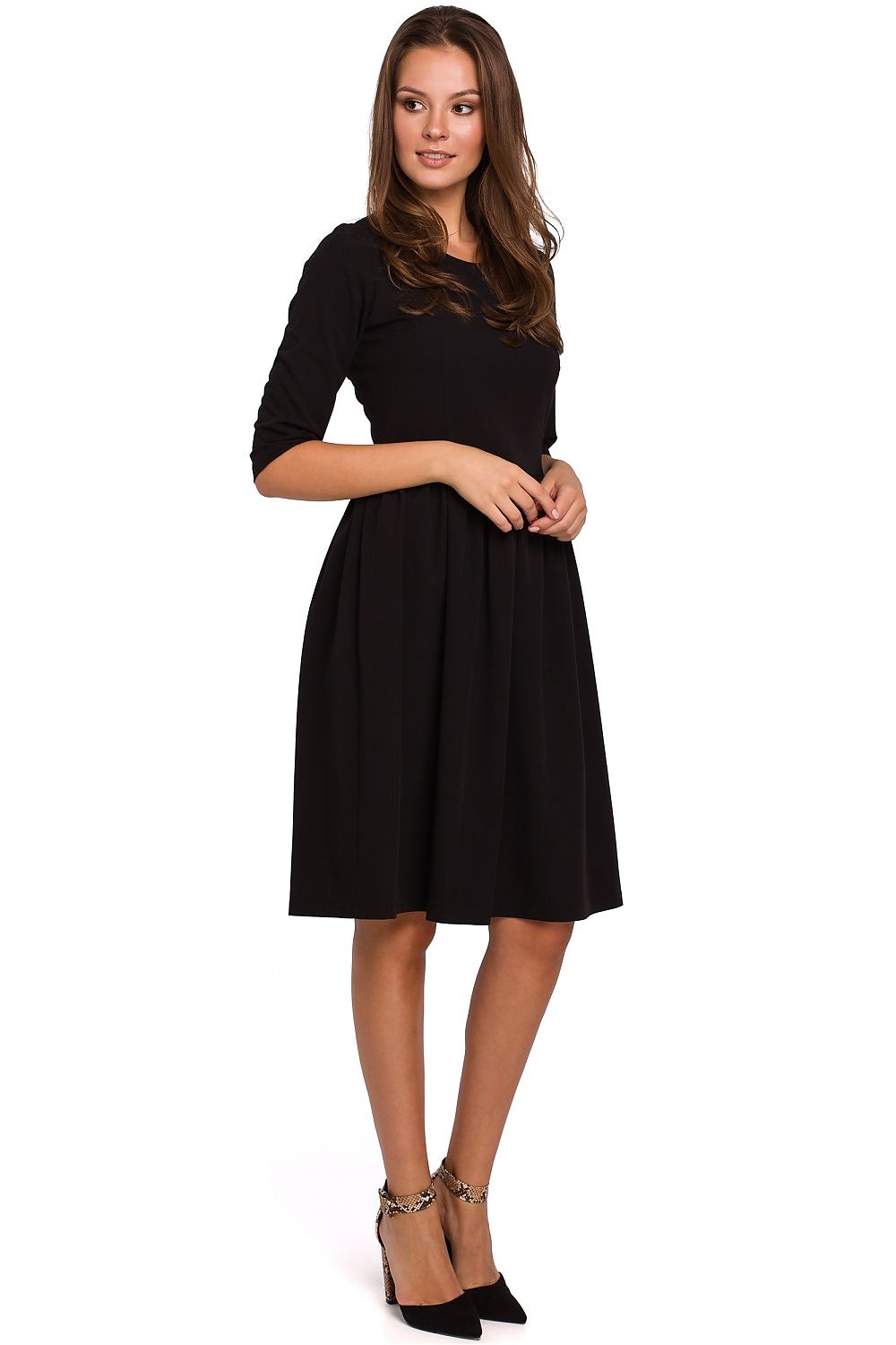 Woman wearing a black dress on a white background