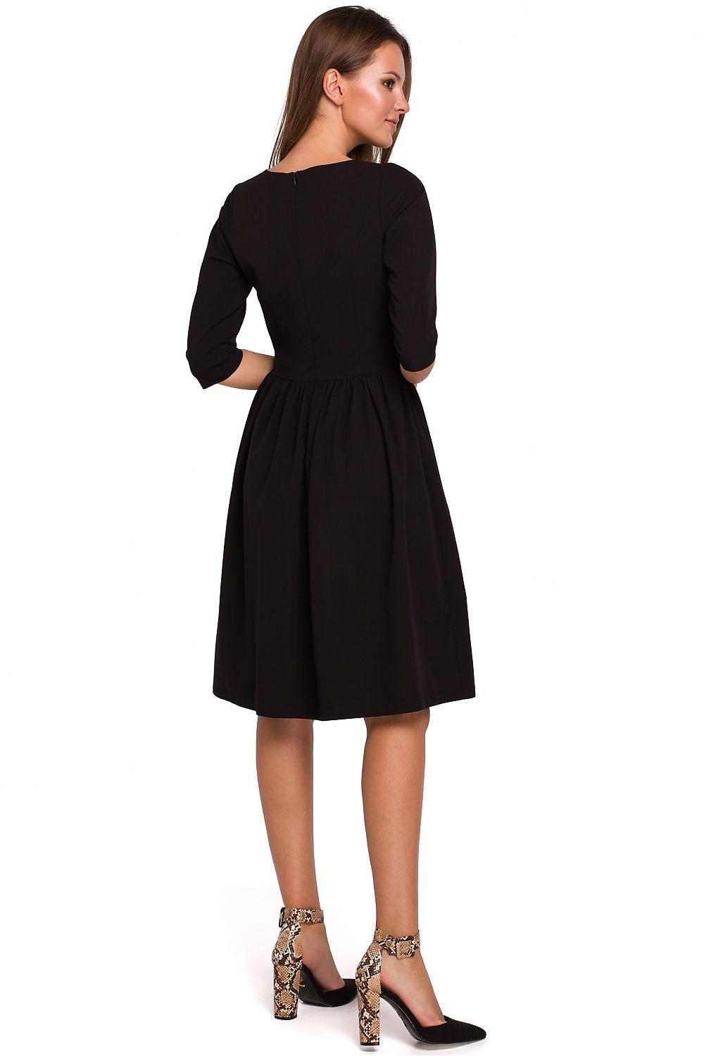 Woman wearing a black dress on a white background