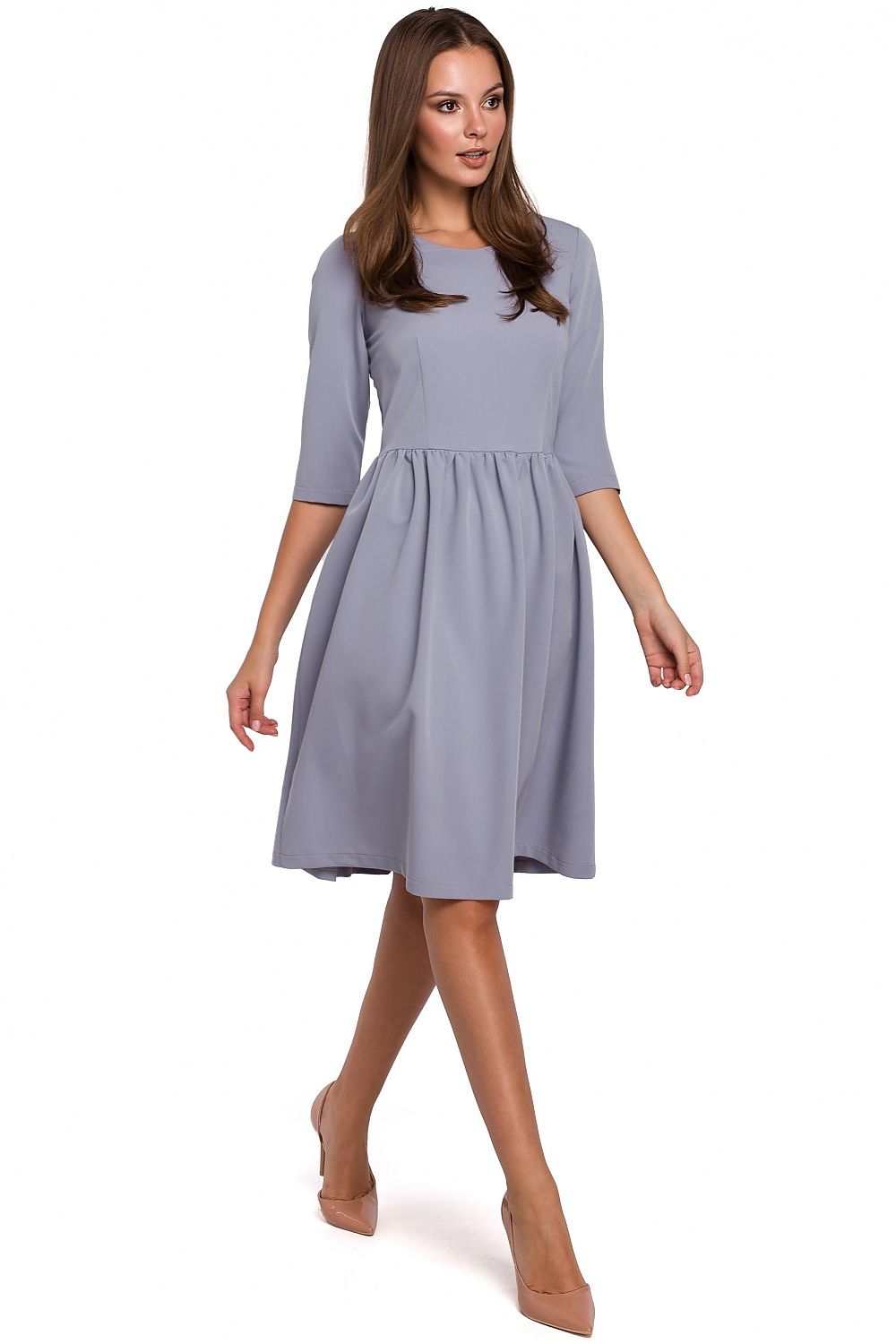 Woman wearing a light blue dress on a white background