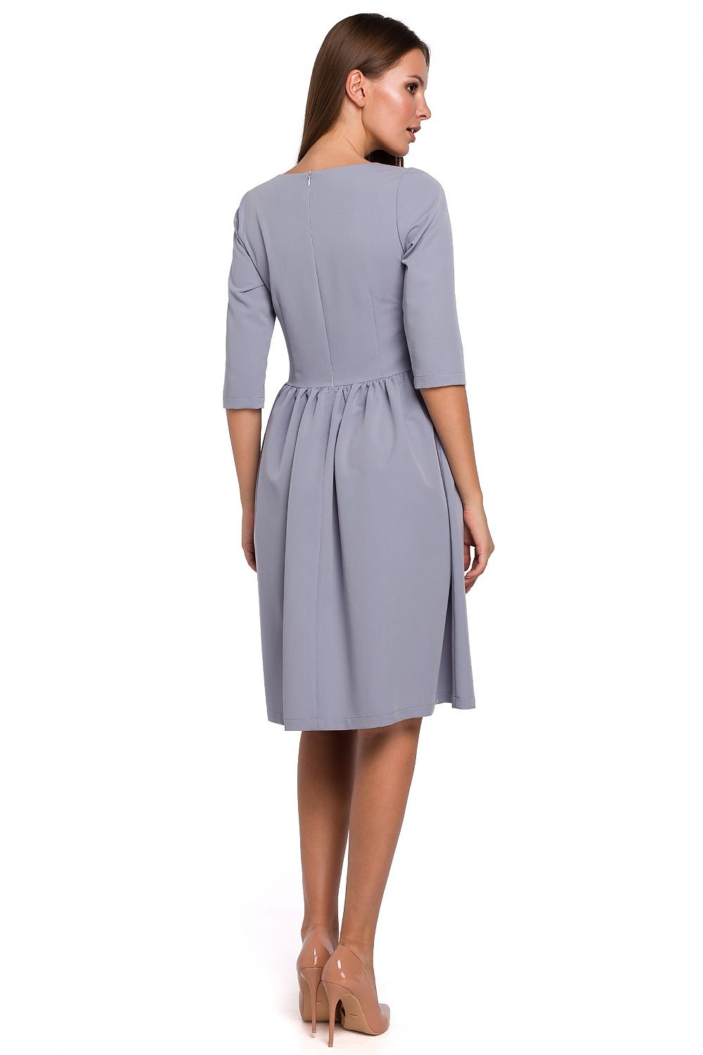 Woman wearing a gray dress on a white background