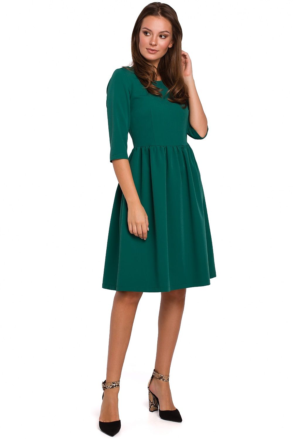 Woman wearing a green dress on a white background