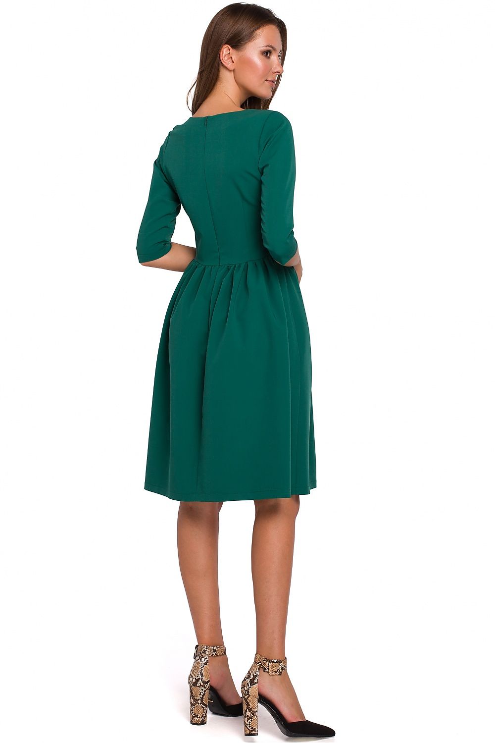 Woman wearing a green dress on a white background