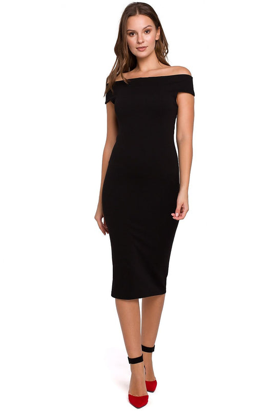 Woman wearing a black off-shoulder dress on a white background