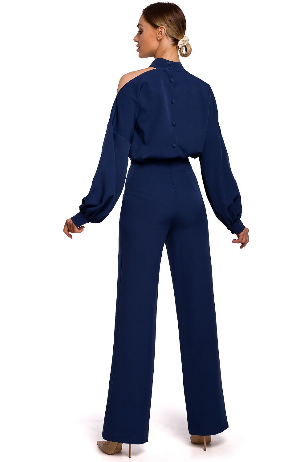 Woman wearing a navy blue jumpsuit on a white background