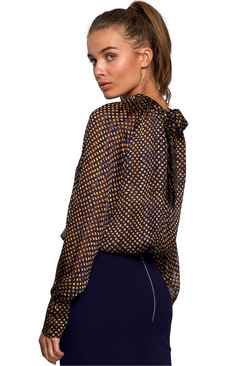 Woman wearing a patterned blouse on a white background