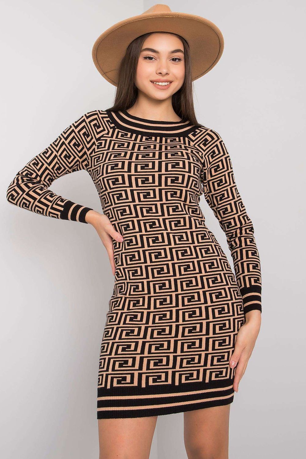 Woman wearing a patterned dress with a plain background