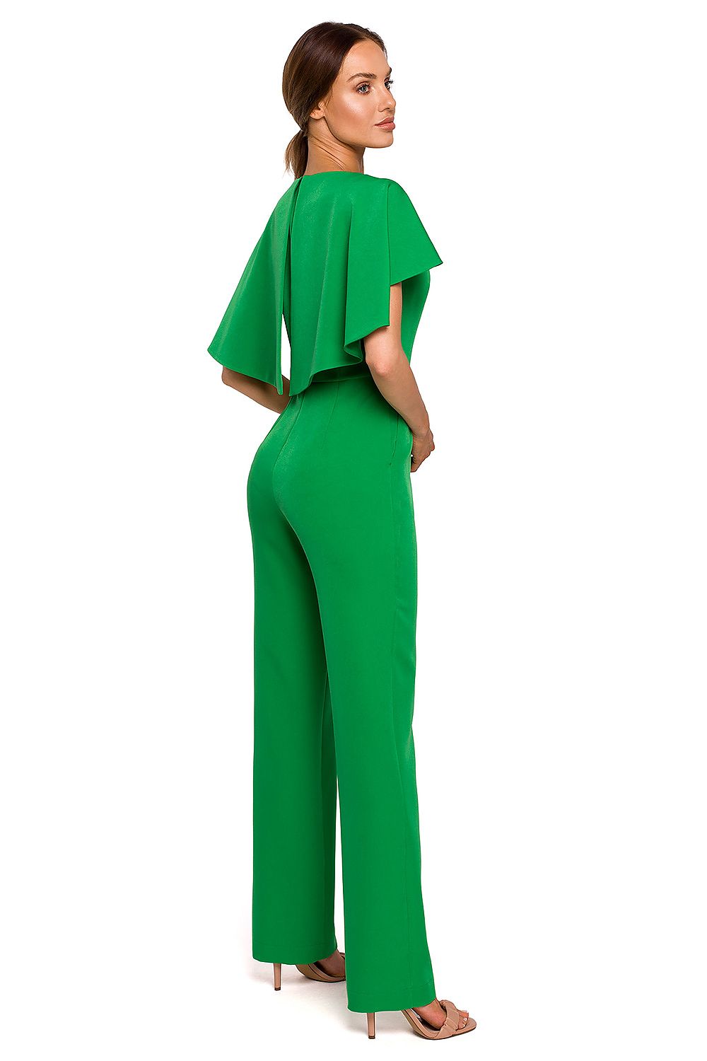 Woman wearing a green jumpsuit on a white background