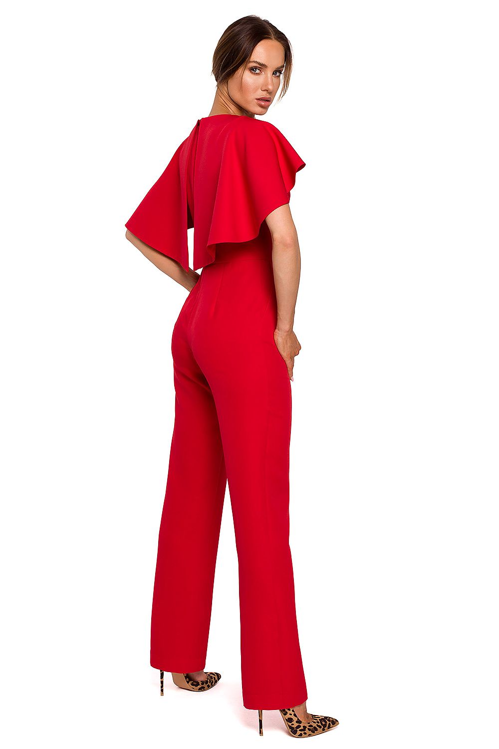 Woman wearing a red jumpsuit with ruffled top on a white background