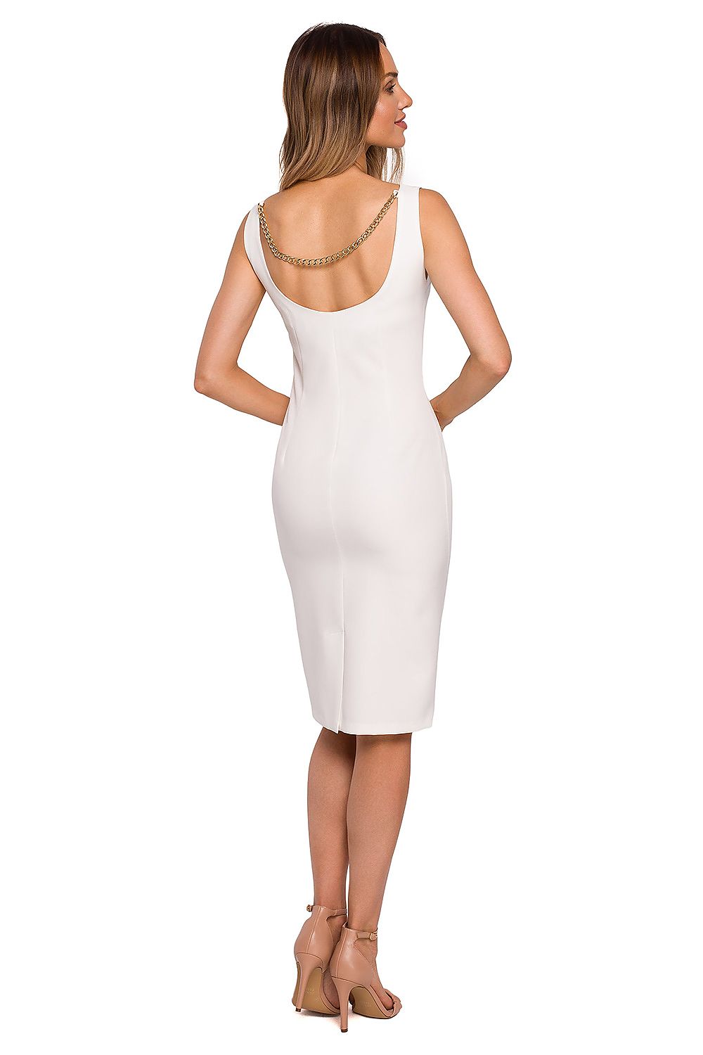Woman wearing a white dress with a chain detail on a white background
