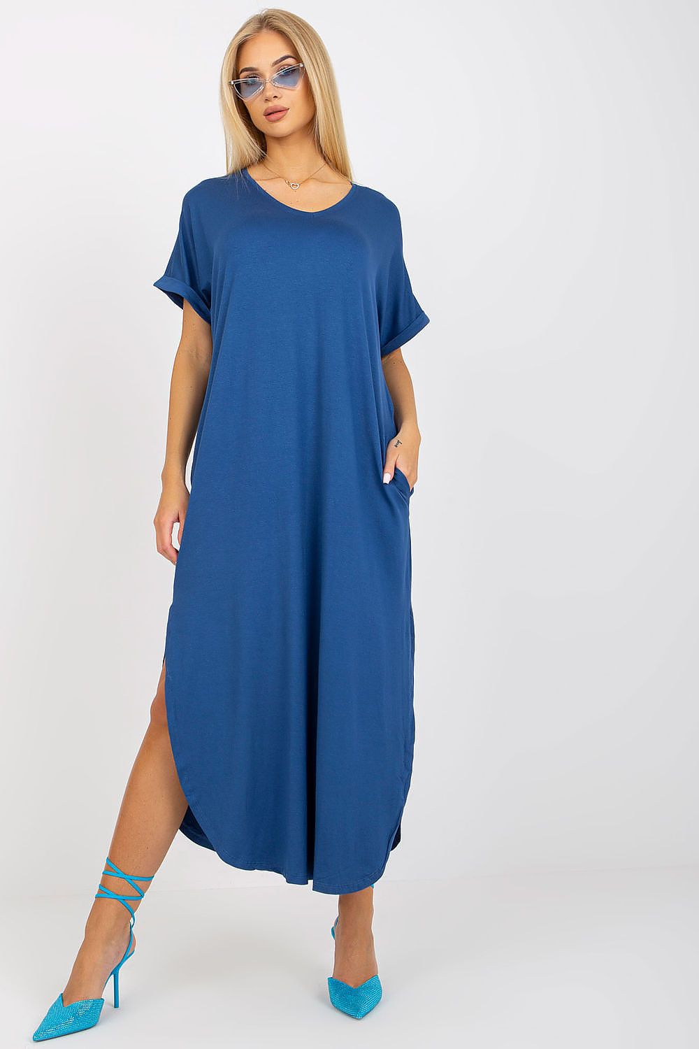 Woman wearing a blue dress with a white background