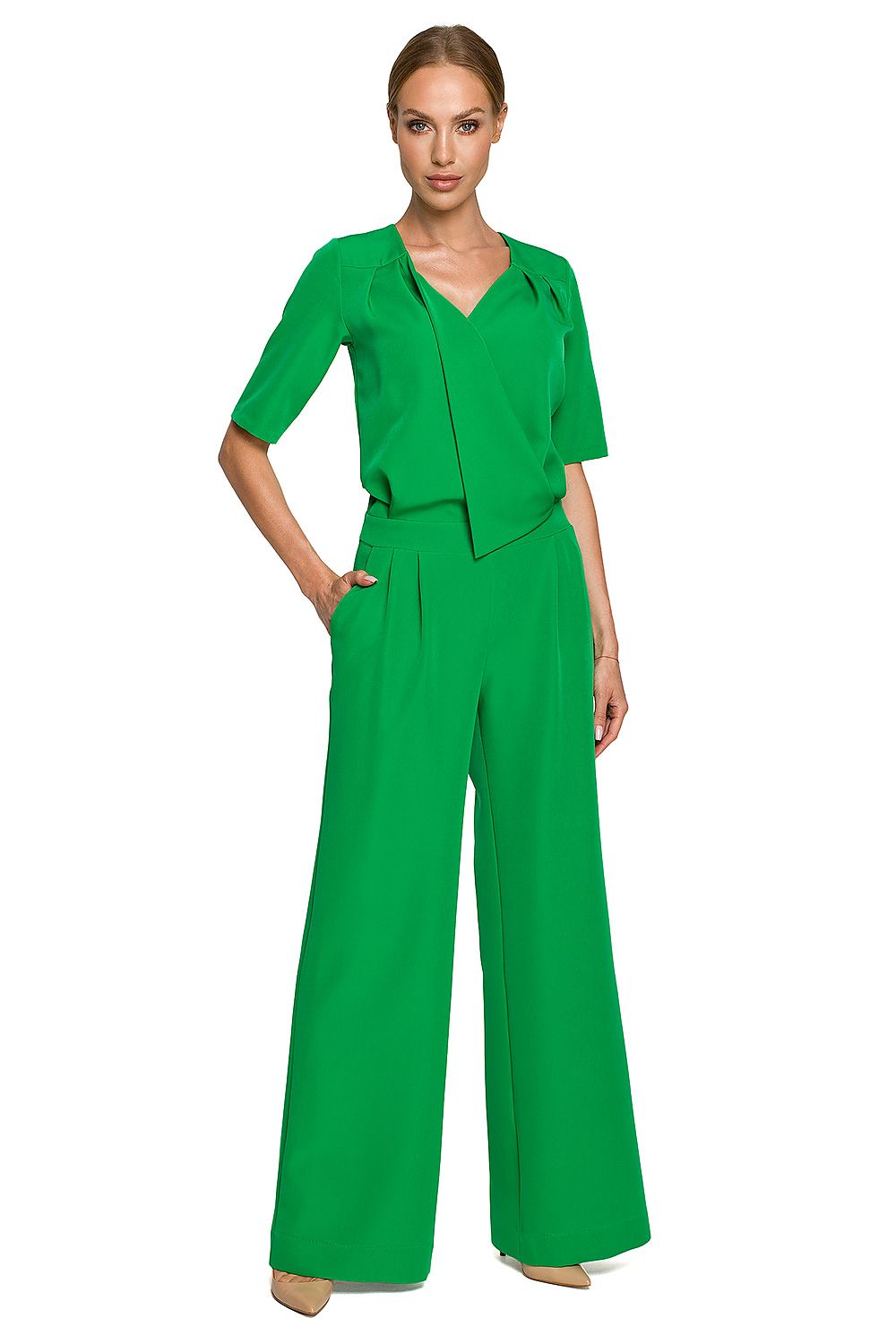 Woman wearing a green jumpsuit on a white background