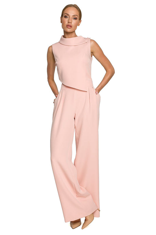 Woman wearing a pink jumpsuit on a white background