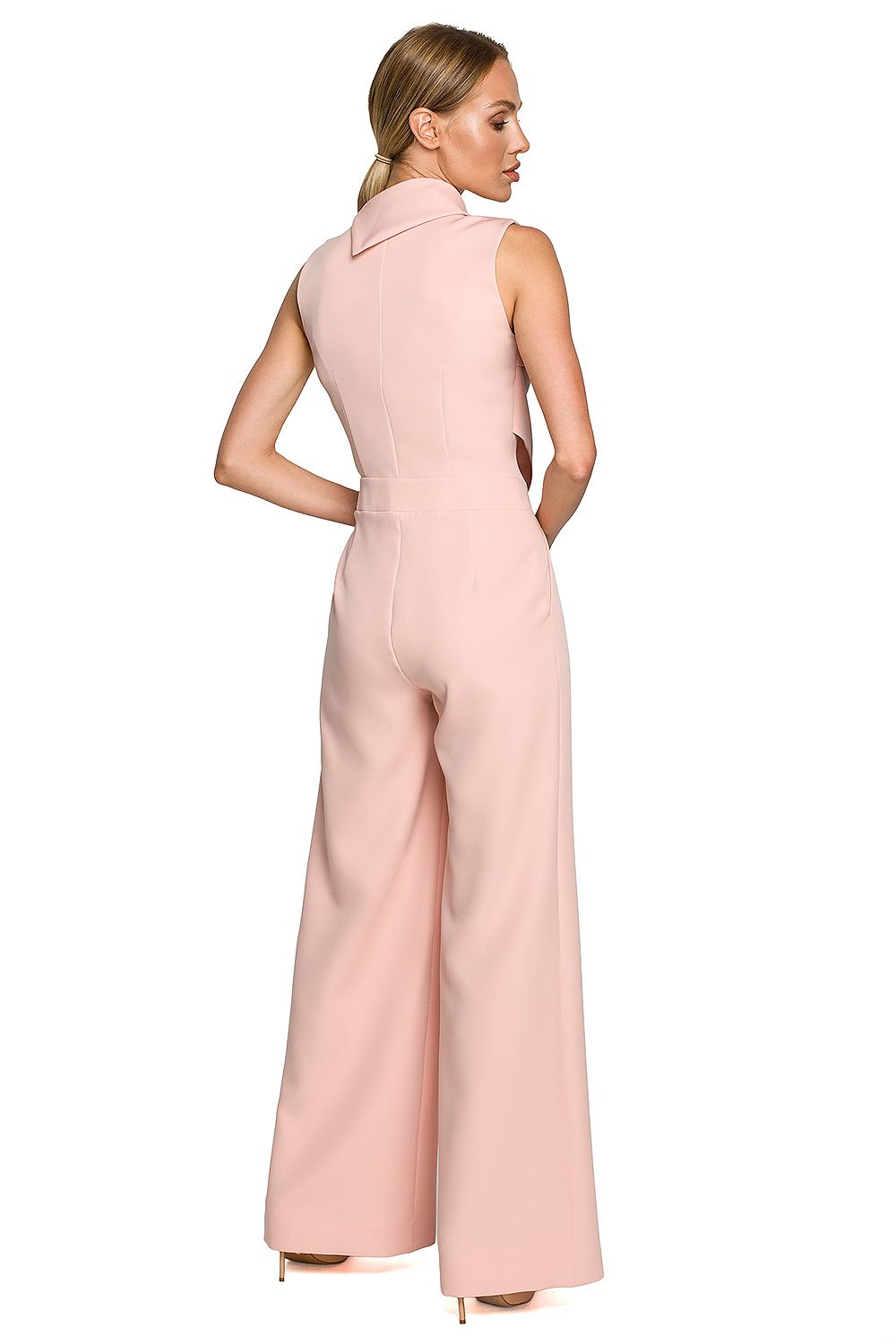 Woman wearing a pink jumpsuit on a white background