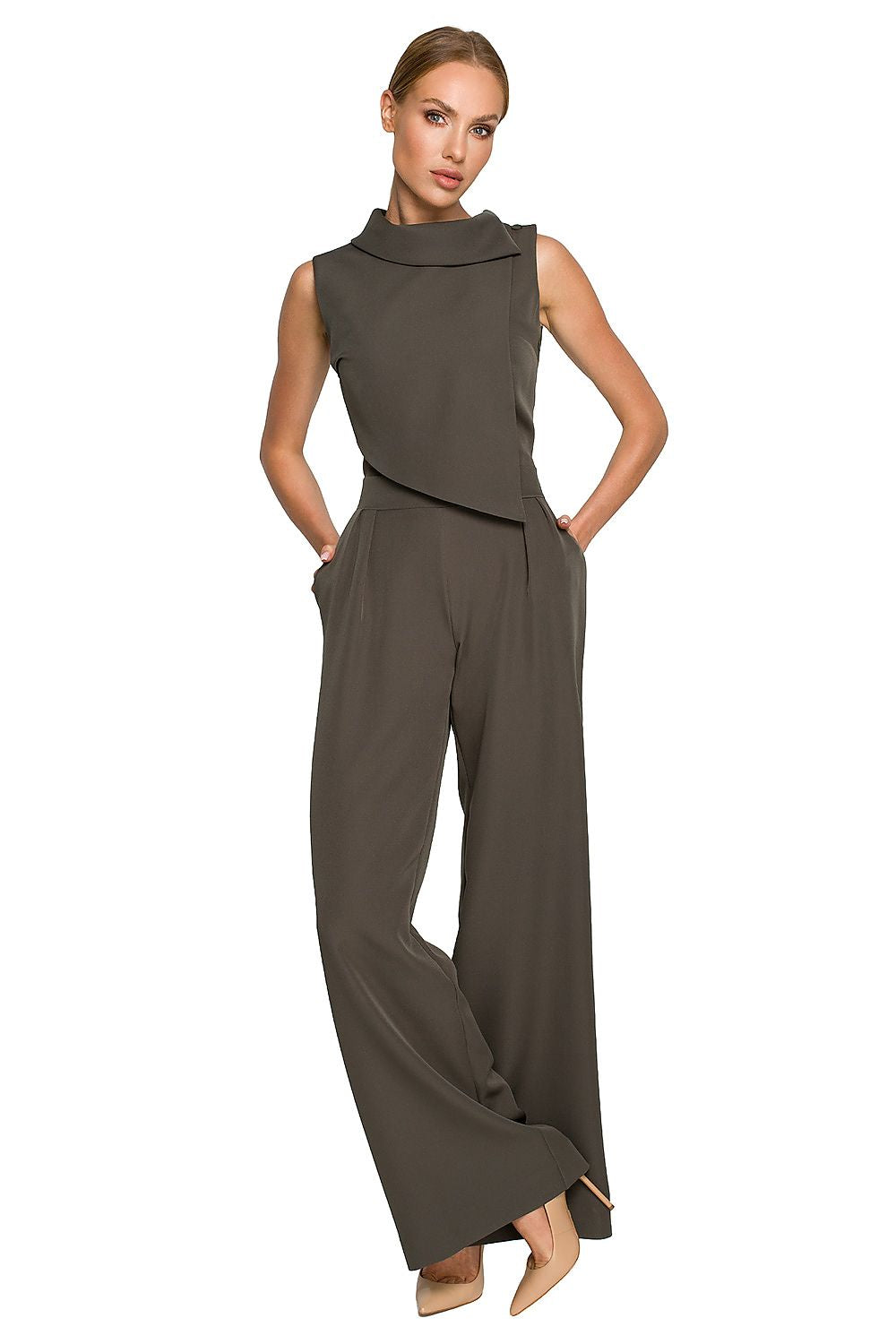 Woman wearing a brown jumpsuit on a white background