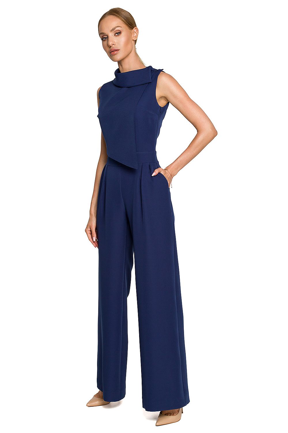Woman wearing a blue jumpsuit on a white background