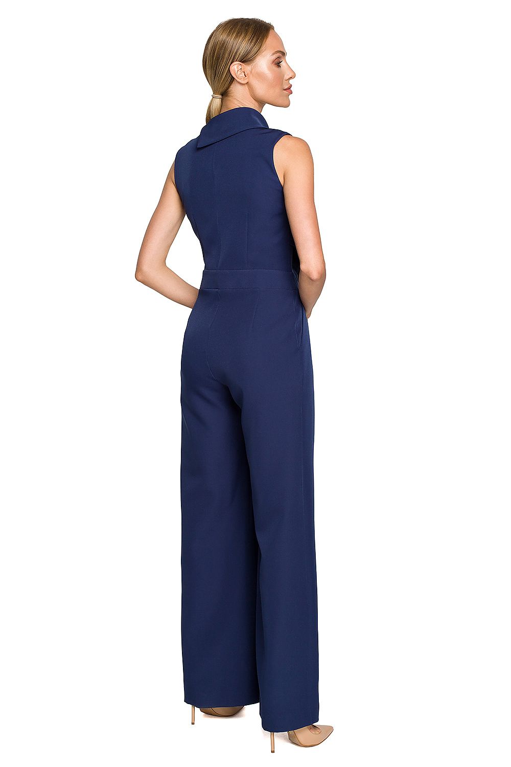 Woman wearing a navy blue jumpsuit on a white background