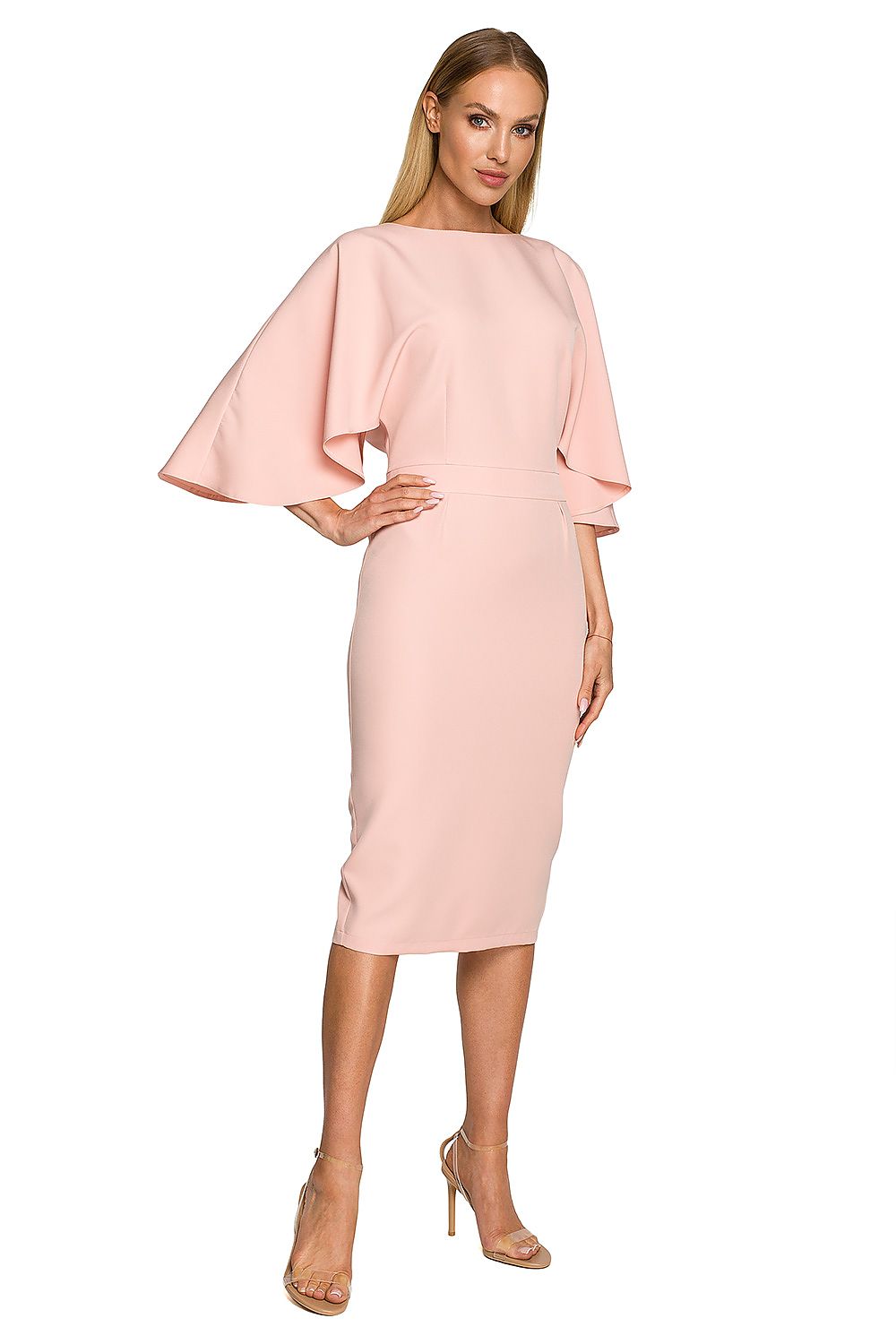 Woman wearing a pink dress with cape sleeves on a white background